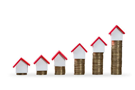 House Models On Top Of Increasing Stacked Coins Over White Backgroundの写真素材