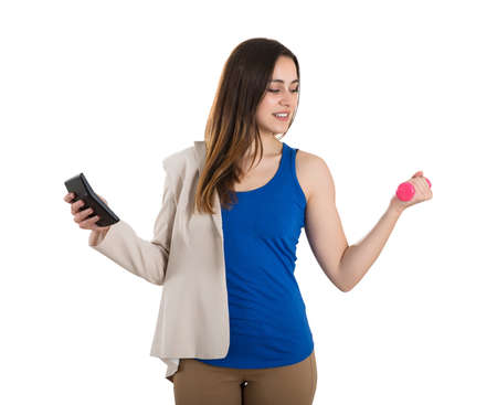 Close-up Of A Woman Holding Calculator Exercising With Dumbbells On White Background