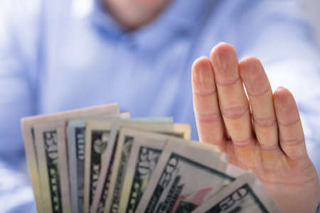 Close-up Of Man's Hand Rejecting An Offer Of Money