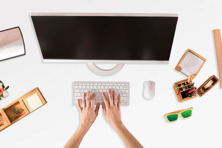 Businessperson Using Computer With Blank Screen At Workplaceの写真素材