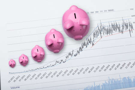 High Angle View Of Pink Piggy Banks Showing Growth On Financial Chart