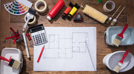 Elevated View Of Blueprint With Paint Brush And Tubes Of Paint On Wooden Background