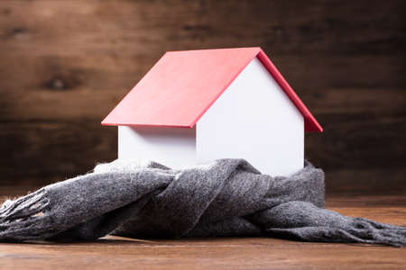 Elevated View Of Scarf Around The House Model On The Wooden Tableの写真素材