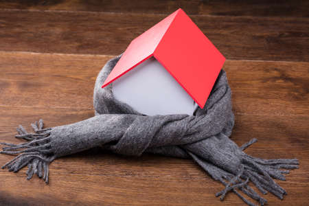 Elevated View Of Scarf Around The House Model On The Wooden Tableの写真素材