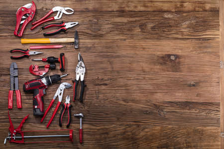 Elevated View Of Various Worktools On Wooden Desk