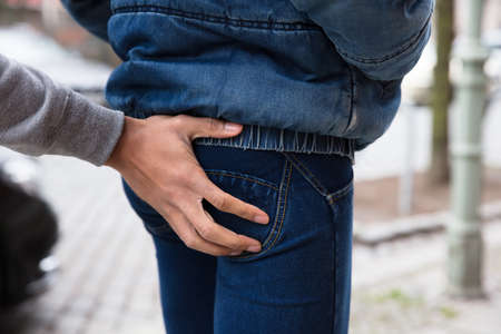 Close-up Of A Man's Hand Touching Woman's Buttockの写真素材