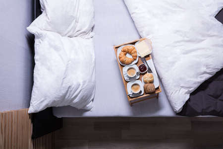 Fresh Croissants And Cup Of Tea On Bed At Breakfastの写真素材