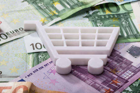 Close-up Of White Shopping Cart On Euro Banknotesの写真素材