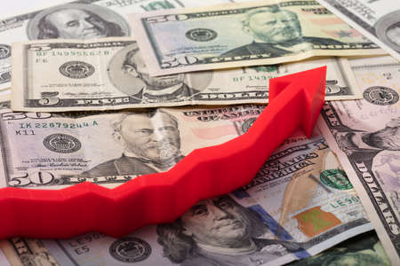 Close-up Of Red Arrow Sign On American Banknotesの写真素材