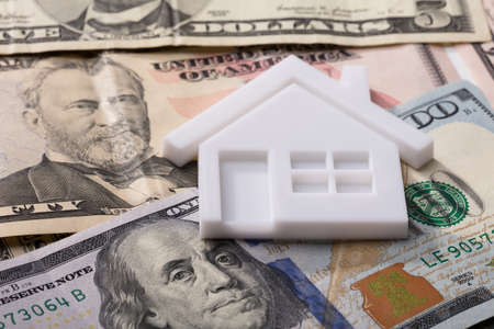 Close-up Of House Model With Red Roof On American Banknotesの写真素材