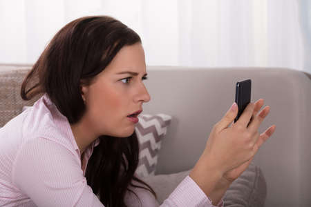 Close-up Of A Young Woman Looking At Smartphoneの写真素材