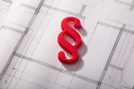 High Angle View Of Red Paragraph Symbol On Blueprint