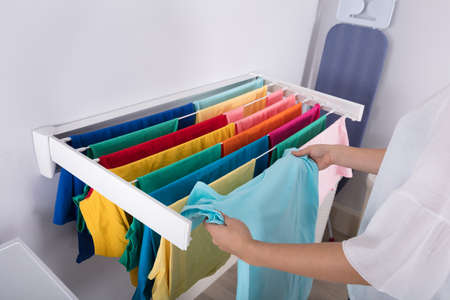 Close-up Of A Woman's Hand Hanging Clothes On Clothes Line