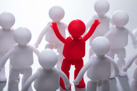 Red Human Figure Surrounded By Team Representing Unity