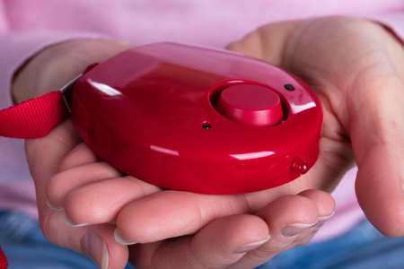 Close-up Of Woman Holding Personal Alarm On Her Hands