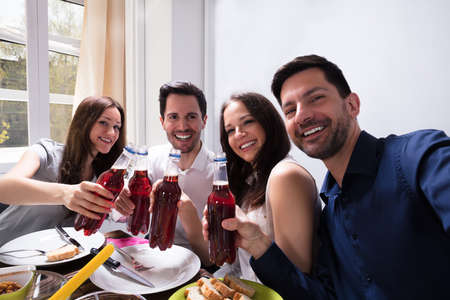 Portrait Of Smiling Young Friends Celebrating Together