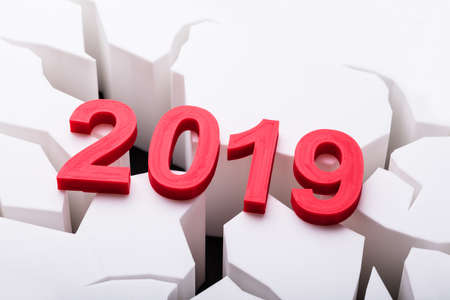 Close-up Of Colorful Year 2019 On Damaged White Surface