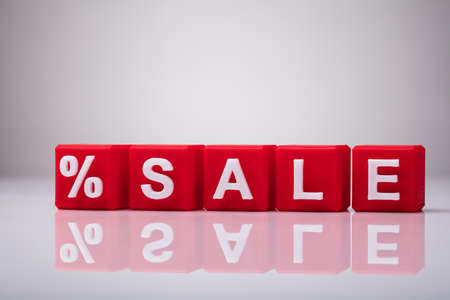 Red Cubic Blocks With Percentage Symbol And Word Sale On Reflective Backgroundの写真素材