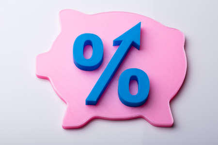 Blue Percentage Symbol Over Pink Piggybank Isolated On White Backgroundの写真素材