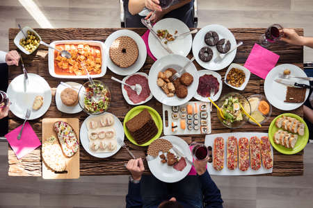 High Angle View Of Young Friends Having Lunch Together