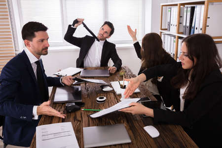 Group Of Frustrated Young Businesspeople Having Discussion In Meetingの写真素材