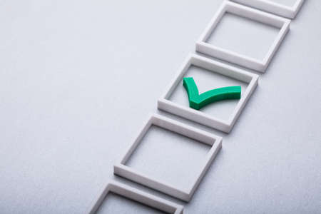 Elevated View Of Green Check Mark In Checkbox On Gray Backgroundの写真素材