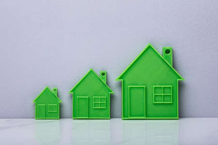 The Scale Of Green House Model On Wall Backgroundの写真素材