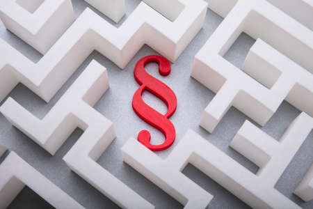 Elevated View Of Red Paragraph Symbol In The Centre Of White Maze