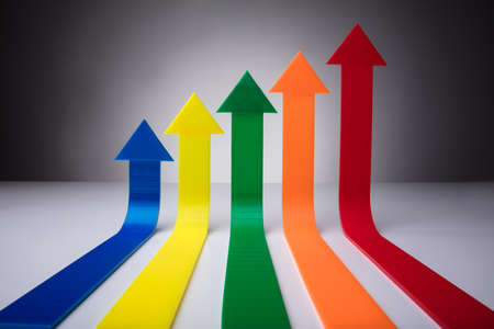 Colorful Arrows Pointing Upwards Against Gray Background