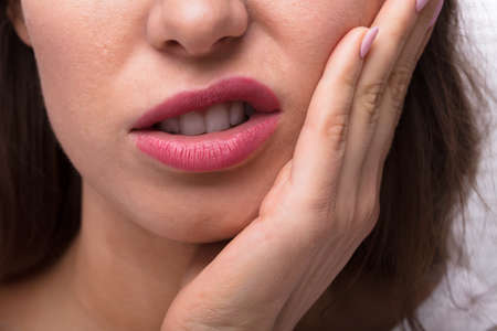 Close-up Of A Woman Suffering From Tooth Painの写真素材