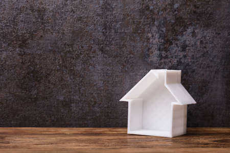 Close-up Of A Hollow White House Model On Wooden Plankの写真素材