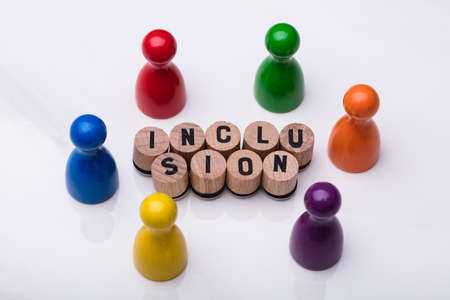 Wooden Cork With Inclusion Text In Front Of Multi Colored Pawn On Reflective Background