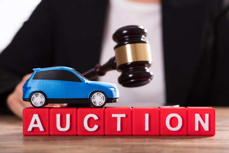 Small Blue Car Over Auction Cubic Blocks