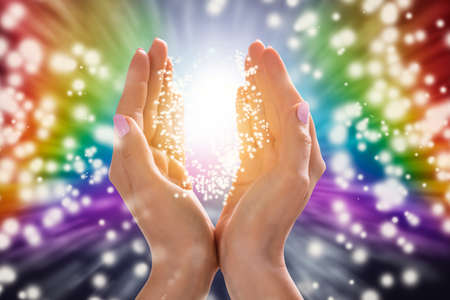 Close-up Of A Woman's Hand Holding Light Against Colorful Background