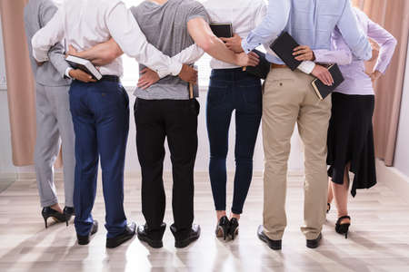 Rear View Of People Standing Together Holding Biblesの写真素材