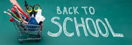 Shopping Cart Filled With School Supplies On Blackboard With Back To School Text