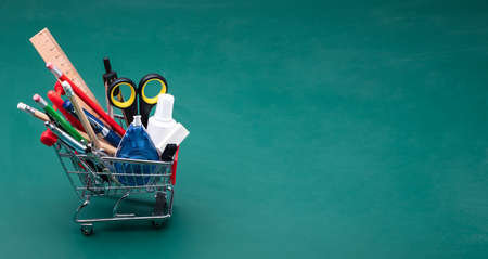 Cart With Various School Supplies On Desk In Classroomの写真素材