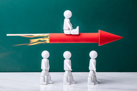 Human Figure Flying Rocket Over Competitors To Achieve Successの写真素材