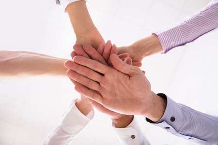 Close-up Of Businesspeople Stacking Hands Over Each Otherの写真素材