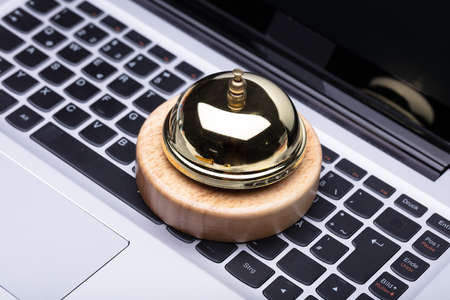 Close-up Of Golden Service Bell On Laptop Keypad