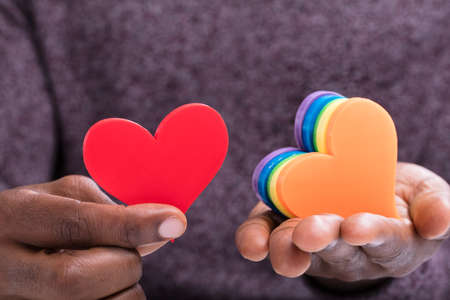 Close-up Of A Person Choosing Red Heart From Colorful Heartsの写真素材