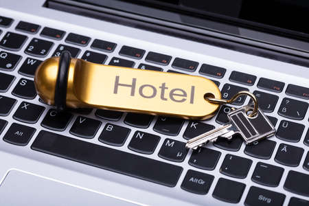 Elevated View Of Hotel Key On Laptop Keypadの写真素材