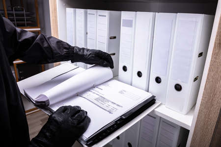 Thief With Black Gloves Holding Invoice Folderの写真素材