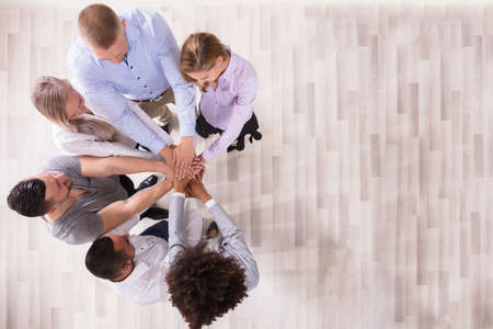 High Angle View Of Team Stacking Their Handsの写真素材