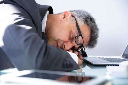 Photo Of Tired Mature Businessman Sleeping In Office