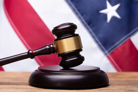 Close-up Of Mallet On Sounding Block In Front Of American Flagの写真素材