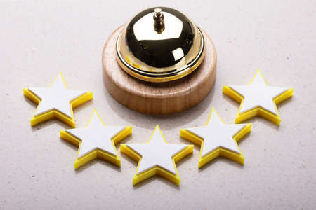 Elevated View Of Service Bell And Five Star Rating Icon On Reception Desk