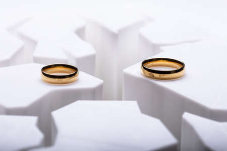 Two Separated Wedding Rings On Cracked Surface