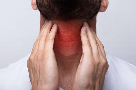 Close-up Of A Man Touching His Sore Throatの写真素材