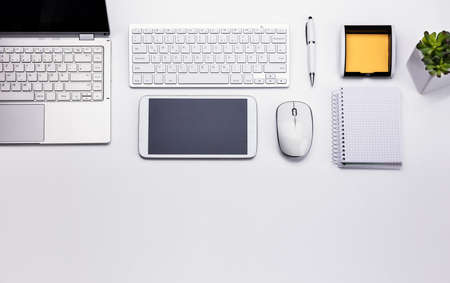 Elevated View Of Various Electronic Devices And Stationeries On White Background